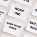 Flat lay of motivational health quotes on paper, promoting healthy habits and self-care.